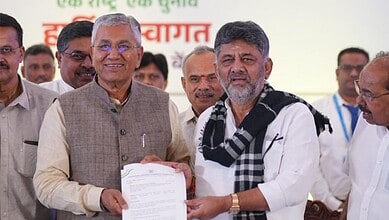 Prominent Indian officials at a public event, exchanging documents and engaging with attendees.