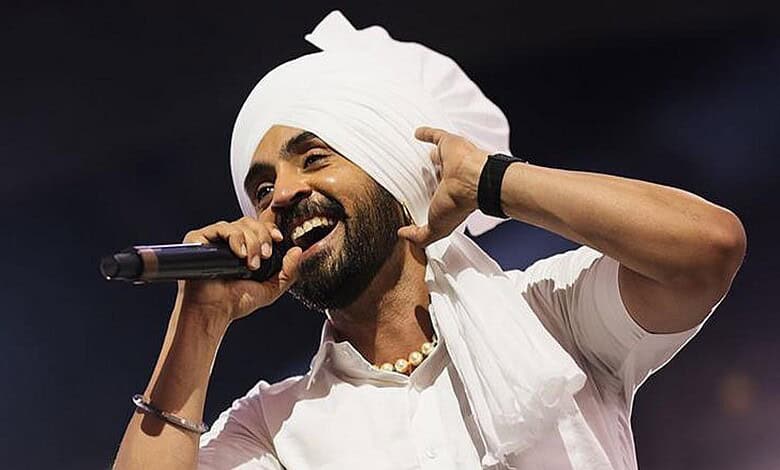 A woman wearing a white turban and traditional attire, singing passionately into a microphone on stage.
