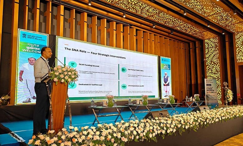 An official presenting at a conference on Telangana's 91K EV registrations in 2025–26, highlighting progr.