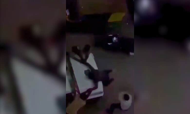 A man is tied to a vehicle's bonnet and appears to be assaulted by police officers in Gujarat over cow sl.