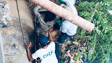 The image shows HYDRAA's DRF team rescuing a woman from the Musi River in Golnaka on Saturday, May 9, 2026.