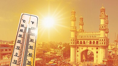 Thermometer showing high temperature at sunset with historic cityscape in the background.