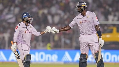 Gujarat Titans' Rahul Tewatia, left, and Jason Holder interact during an Indian Premier League (IPL) 2026 T20 cricket match between Gujarat Titans and Sunrisers Hyderbad, in Ahmedabad, Gujarat, Tuesday, May 12, 2026. (PTI Photo/Shahbaz Khan)