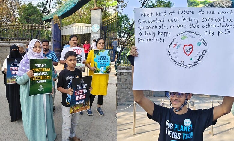 The image shows people protesting at KBR Park against the felling of trees for the construction of flyovers and underpasses around the park on Thursday, May 7, 2026.