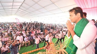 KTR praying with farmers at a large outdoor gathering under a tent.