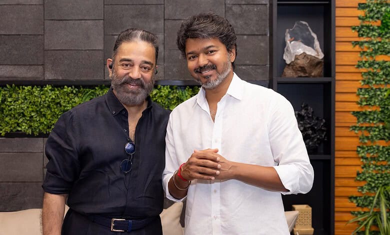 A man in a black shirt and a man in a white shirt smiling together indoors.