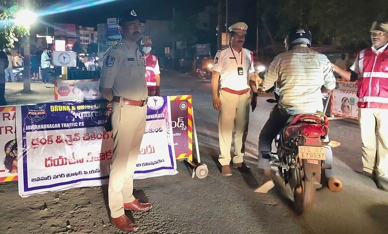 Police officers managing traffic at night with warning signs in the background, ensuring safety and order.