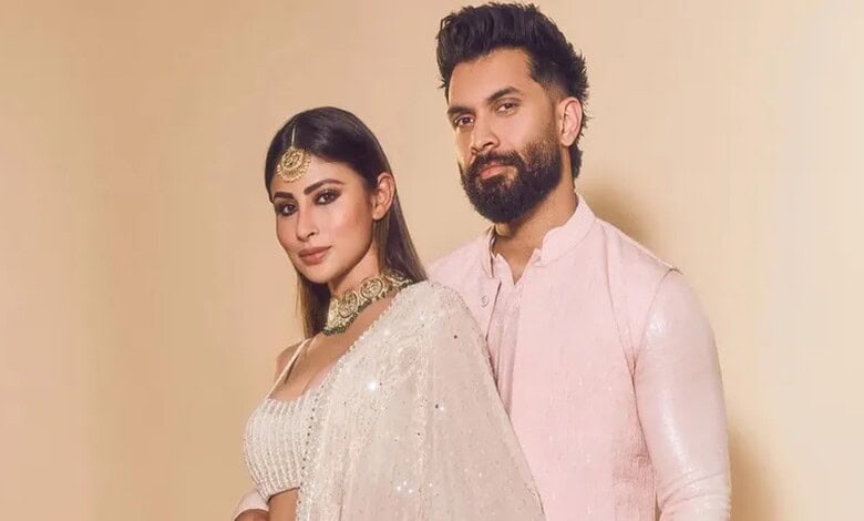 Elegant Indian couple in traditional attire, celebrating cultural festival, showcasing vibrant clothing a.