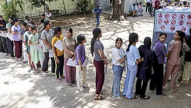 Students standing in line for NEET-UG 2026 exam registration at a centre.