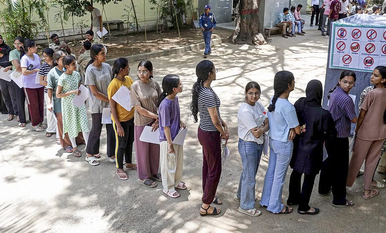 Students standing in line for NEET-UG 2026 exam registration at a centre.