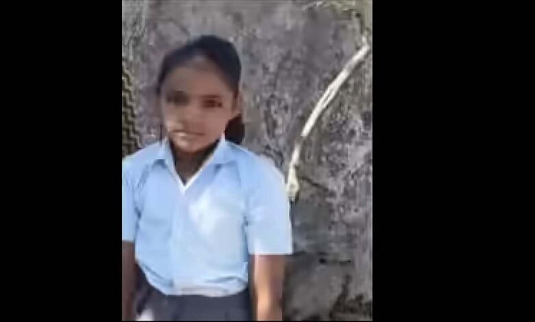 Young girl in school uniform sitting near a tree, showing the impact of stray dog attack in Rajasthan.