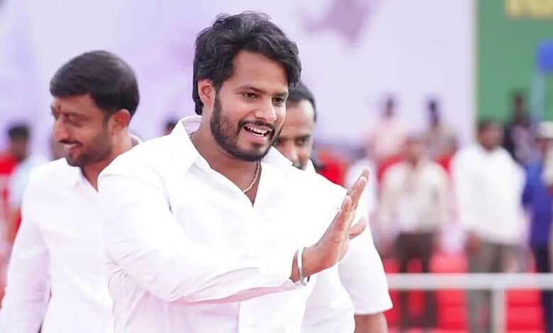 Nikhil Kumaraswamy smiling and waving at the IPL final, highlighting his stance on the Karnataka governme.