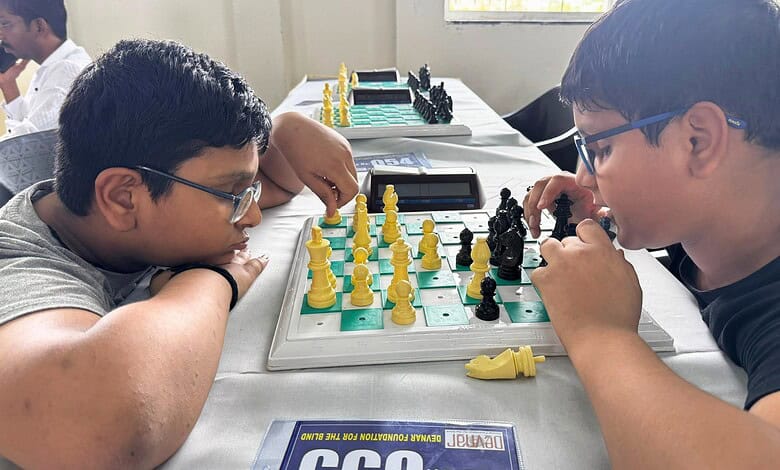 Two blind chess players competing in a game, focusing intensely on the board in Hyderabad.