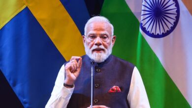 Indian Prime Minister Narendra Modi speaking at a diplomatic event with Sweden and India flags in the bac.