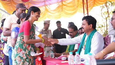 Official greets Telangana minister at housing event.