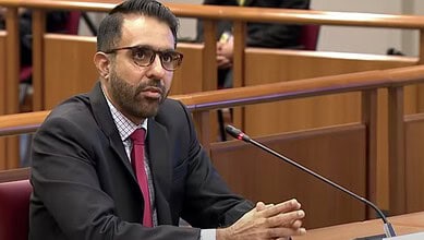 Singapore politician of Indian descent during parliamentary session, facing criticism for dishonesty.