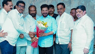 Telangana CM Revanth with officials celebrating at Shamshabad bus terminus site.