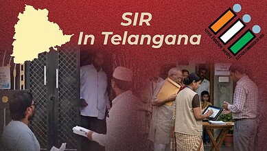 People waiting outside a government office in Telangana, India, with officials assisting and using digita.