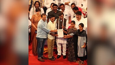 Telangana government provides financial aid to families of deceased gig workers in a formal ceremony.