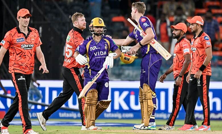 Cricket players celebrating after a match, with team members and officials in a stadium setting.