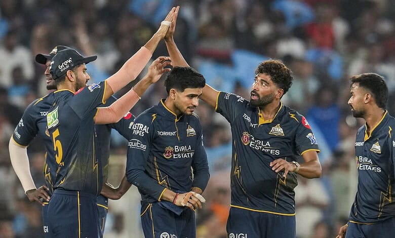 Gujarat Titans players celebrate during the match, showcasing teamwork and sportsmanship in cricket.