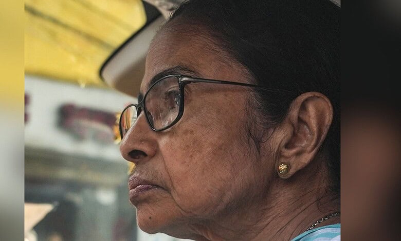 Close-up of an elderly woman in a vehicle, reflecting on the Bengal assembly election results and the BJP.
