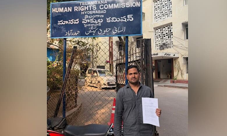Man holding document outside Hyderabad Human Rights Commission office after Madinah bus accident.
