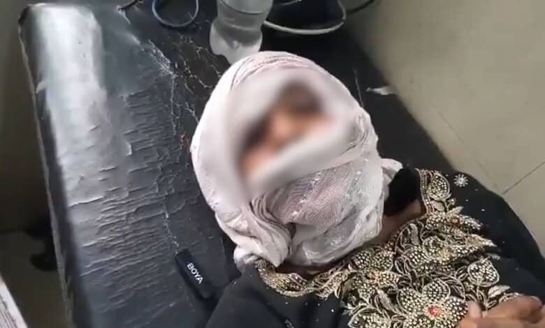 Girl with sindoor on her forehead, lying on a bed, in distress.