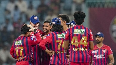 Celebrating cricket players in colourful uniforms during a match, showcasing team spirit and camaraderie.