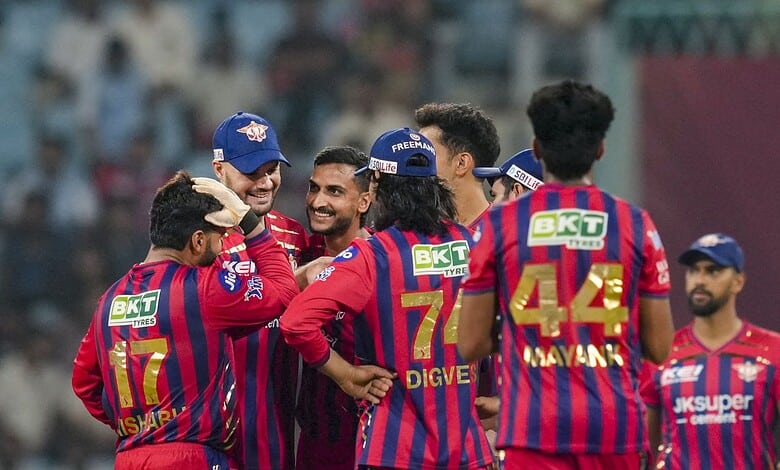 Celebrating cricket players in colourful uniforms during a match, showcasing team spirit and camaraderie.
