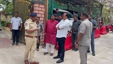 Police officers and officials investigating outside a residence in Hyderabad related to a domestic help m.