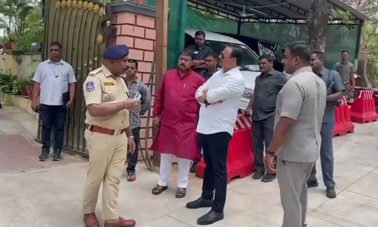 Police officers and officials investigating outside a residence in Hyderabad related to a domestic help m.