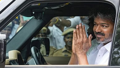 Celebration of Tamil Nadu election victory with Vijay, the new Chief Minister, and supporters in a car.