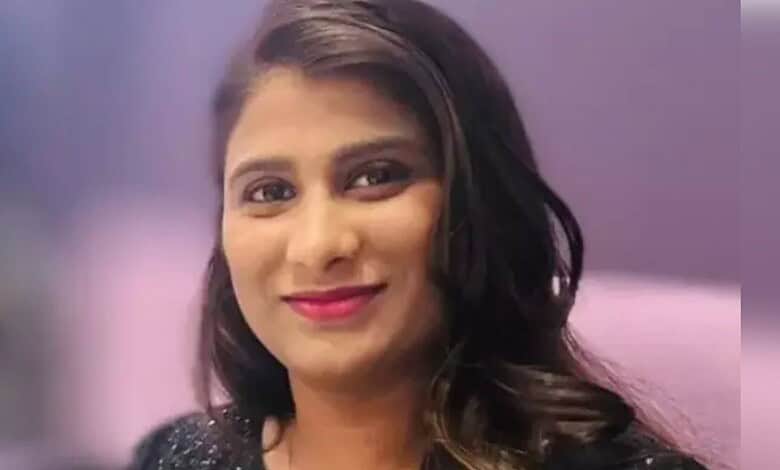 A woman in traditional attire smiling, with a blurred background, representing a Telugu woman in Florida.