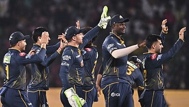The Siasat Daily, cricket players celebrating on the field after a successful match.