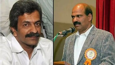 A man with a moustache and white shirt, and another man in a checked blazer speaking at a microphone duri.