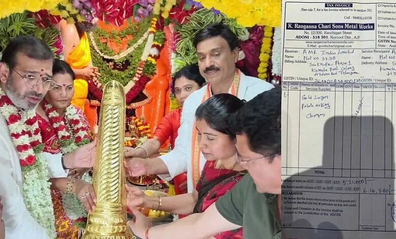 Lighting a traditional lamp during a festive celebration at a cultural event in India.