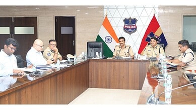 India police officials and government representatives in a formal meeting at a conference room.