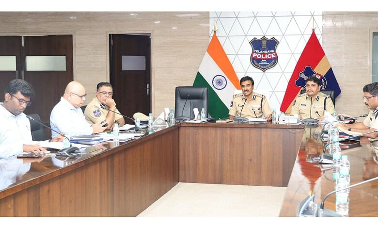 India police officials and government representatives in a formal meeting at a conference room.