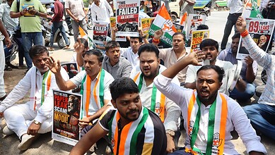 Protesters holding signs and flags during a demonstration advocating for political and social change in I.
