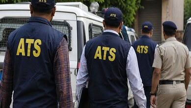ATS officers in uniform inspecting a vehicle during an operation, demonstrating law enforcement activity.