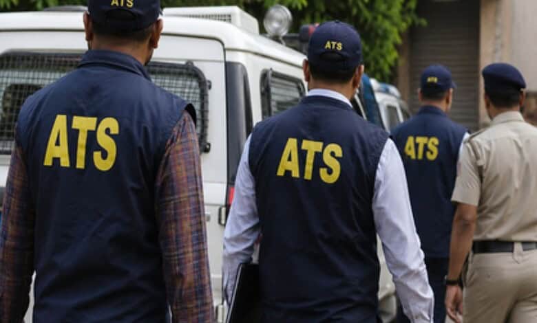 ATS officers in uniform inspecting a vehicle during an operation, demonstrating law enforcement activity.