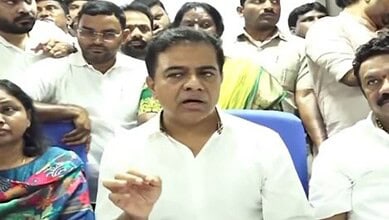 A man speaking to a group of people during a press conference or meeting.
