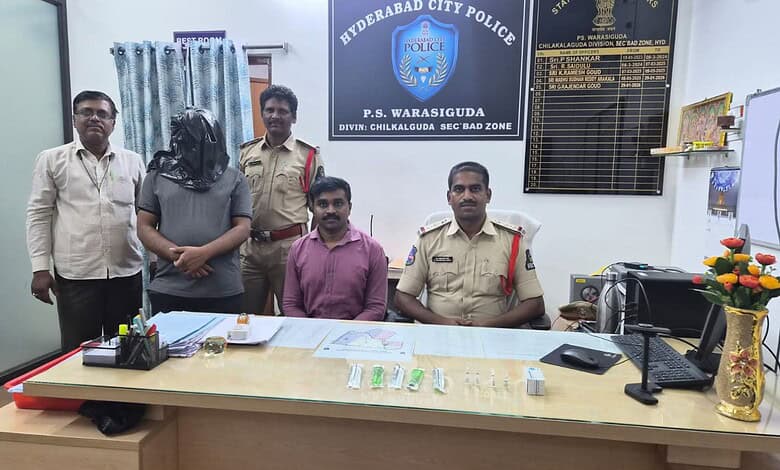 Police officers and staff members seated and standing in Hyderabad City Police office, Hyderabad, Telanga.