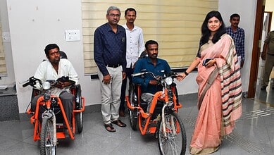 Accessible transportation initiative with individuals using adaptive bikes and supportive staff.