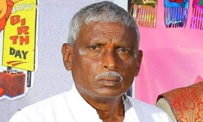 A man with grey hair and a serious expression, celebrating a birthday with colourful decorations and a "H.