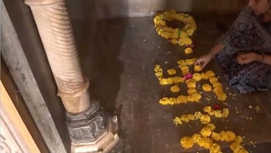 Diwali ritual with flower petals and candles on the floor, person arranging flowers for festival prayers,.