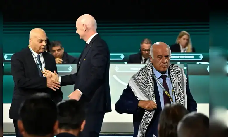 FIFA president Gianni Infantino shakes hands with Israeli FA chief Moshe Zuares as Palestinian FA head Jibril Rajoub walks off stage.