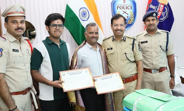 Police officials with two men holding certificates in Hyderabad.