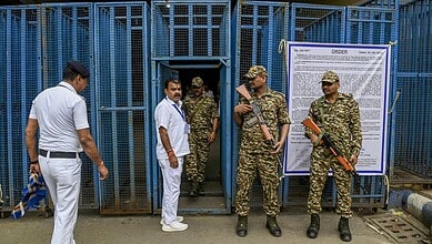 Election security personnel standing outside polling station in Bengal.